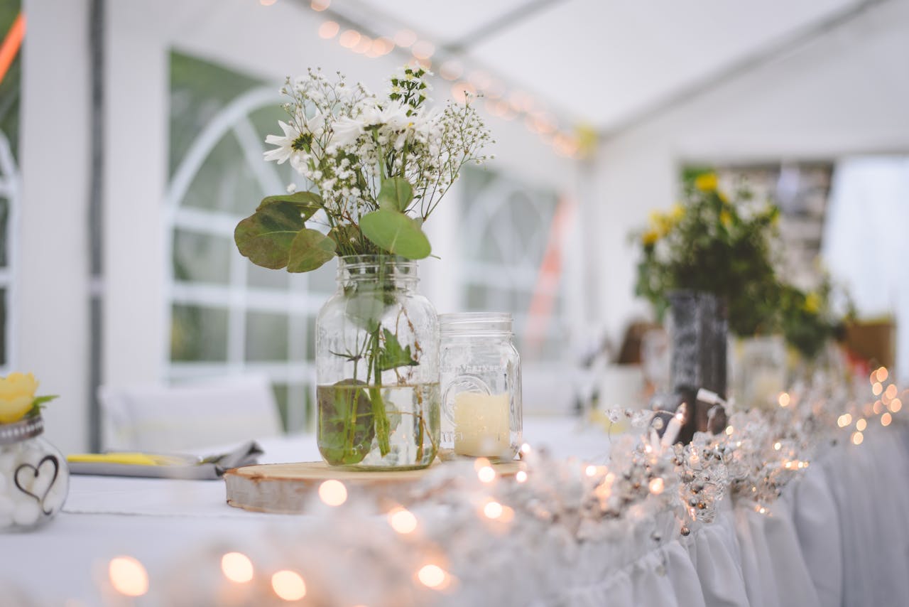 Charming wedding reception with a floral centerpiece and string lights.